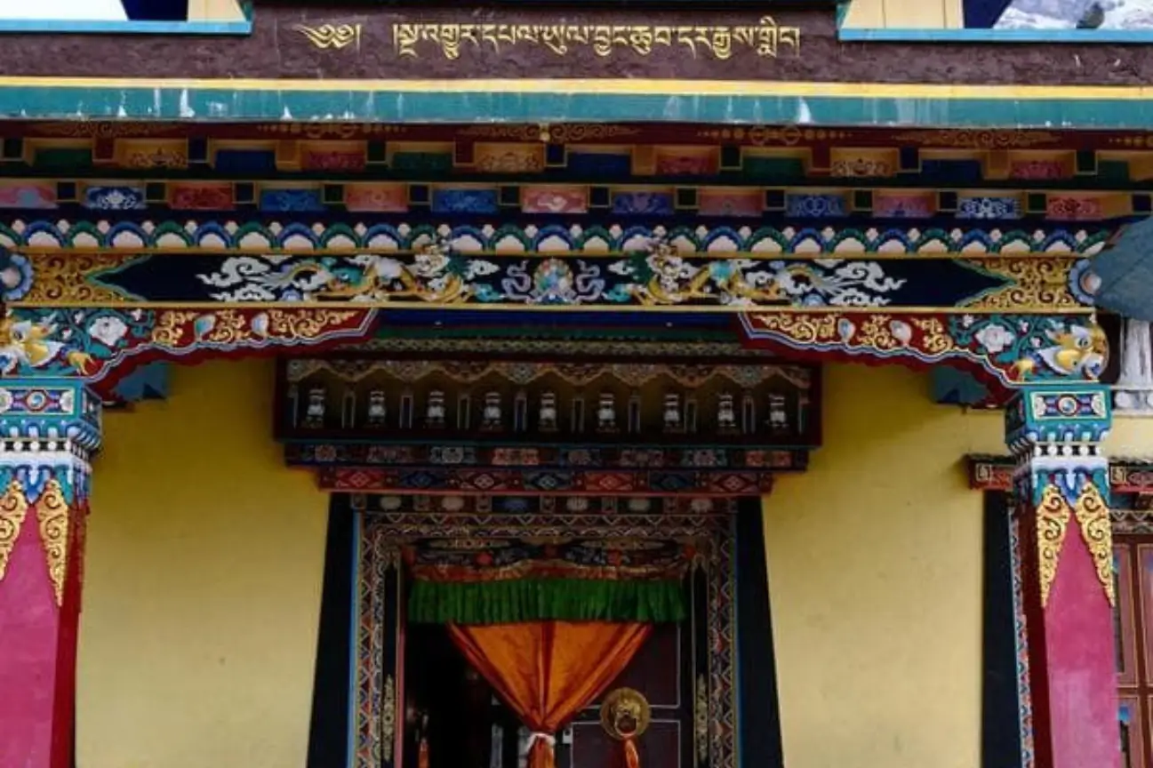 Ornate traditional Tibetan Buddhist monastery architecture with colorful wooden carvings during Nepal trek tours.